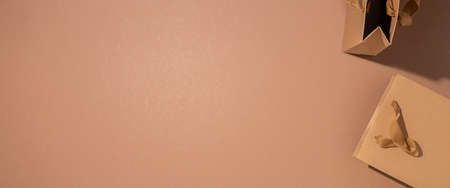 Craft bags for a gift on a brown background. Top view, flat lay. Banner.