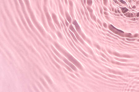 Texture wave from drops on pink water under sunlight. Top view, flat lay.の写真素材