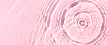 Texture of drops on pink water under sunlight. Top view, flat lay. Banner.の写真素材