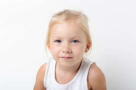 Beautiful pensive blonde girl on a light background in the studio.の写真素材