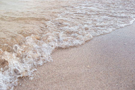 Soft transparent wave of the sea on a sandy beach.の写真素材