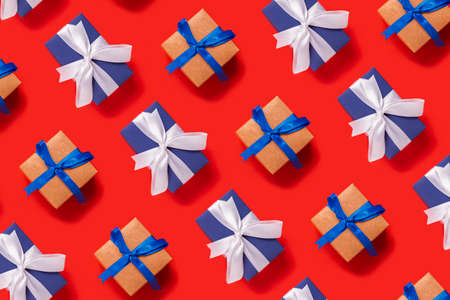 Lots of Christmas gift boxes on a red background. Top view, flat lay.の写真素材