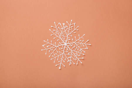 Snowflake on a brown background. Concept for New Years and Christmas Eve. Banner. Flat lay, top view.の写真素材
