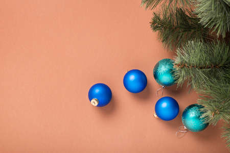 Fir branches and Christmas tree decorations on a brown background. Concept for New Years and Christmas Eve. Banner.の写真素材