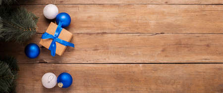 Gifts, Christmas decorations and a Christmas tree on a wooden background. Banner. Flat lay, top view.の写真素材