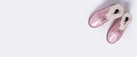 Children's pink shoes on a white background. Top view, flat lay. Bannerの写真素材