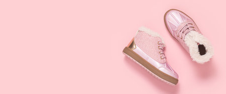 Fashionable baby shoes on a pink background. Top view, flat lay. Bannerの写真素材