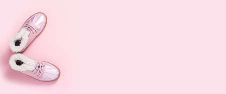 Boots for a girl on a pink background. Top view, flat lay. Bannerの写真素材