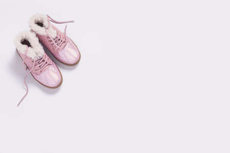 Fashionable children's boots for a girl on a white background. Top view, flat lay