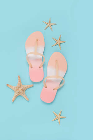 Beach flip flops, starfish on a blue background. Top view, flat layの写真素材
