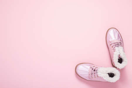 Boots for a girl on a pink background. Top view, flat layの写真素材
