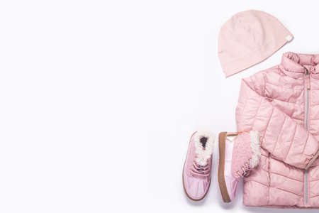 Kids jacket, hat and boots for a girl on a white background. Top view, flat layの写真素材