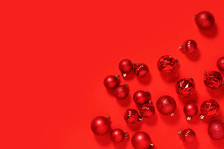 Red decorative balls in a white square pedestal on a red background