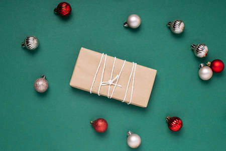 Gifts, decorative balls on a dark green background. Top view, flat layの写真素材