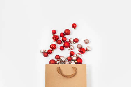 Decorative balls fall out from a craft gift bag on a white background. Top view, flat layの写真素材