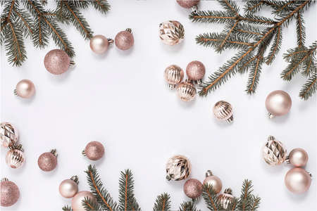 Decorative gold balls and sprigs of spruce on a white background. Top view, flat layの写真素材