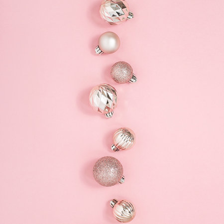 Decorative pink shiny balls on a pink background. Top view, flat layの写真素材