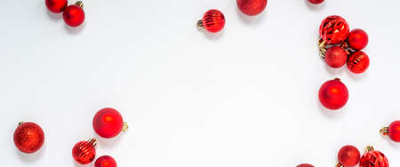 Decorative red balls on a white background. Top view, flat lay. Bannerの写真素材