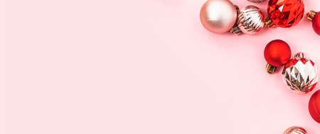 Decorative red and pink balls on a pink background. Top view, flat lay. Bannerの写真素材