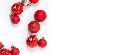 Decorative red balls on a white background. Top view, flat lay. Bannerの写真素材