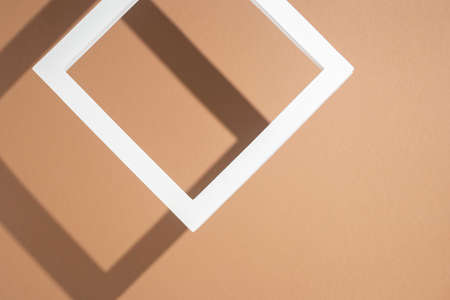 White presentation podium frame on brown background. Top view, flat lay.の写真素材