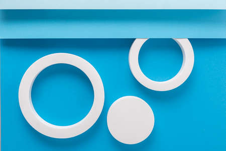 Round podiums on light blue background design of folded paper material. Top view, flat lay.の写真素材