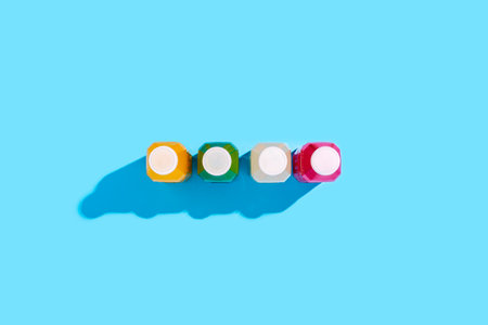 Colored detox drink in plastic bottles on a blue background. top view, flat lay