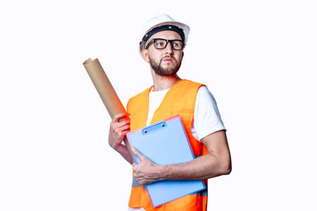 Young man with glasses in building clothes, with a clipboard on a light background