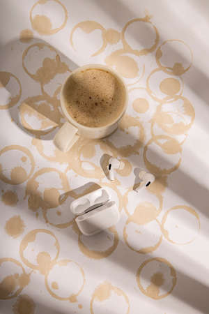 Table with traces of coffee cups. Coffee, headphones. Flat lay, top viewの写真素材