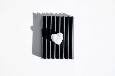 White heart on a decorative cardboard stand. Flat lay, top view.
