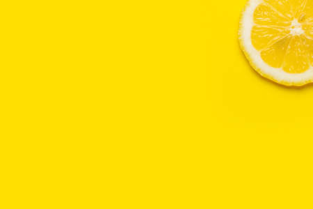 slice of yellow lemon on a yellow background. Top view, flat lay.の写真素材