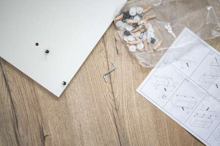 Furniture assembly, furniture assembly instructions on a wooden background. top view, flat layの写真素材