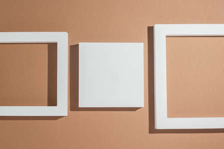White square podiums for presentations on a brown background. Top view, flat lay.の写真素材