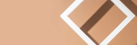 White presentation podium frame on a light brown background. Top view, flat lay. Banner.の写真素材