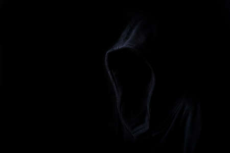Faces are not visible in black robes in the dark on a black background.