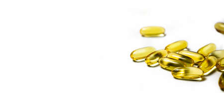 Vitamins in capsules fish oil, omega 3 and vitamin D on a white background. Banner