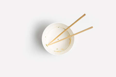 Empty paper bowl with chinese stick on white background.Top view, flay lay.の写真素材