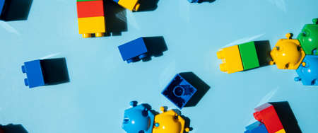 Constructor children's plastic multi-colored on a blue background. Top view, flat lay. Banner.の写真素材