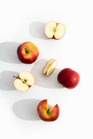 Whole, halves and cut apples on a white background. Top view, flat lay.の写真素材