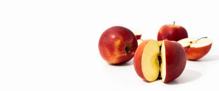 Whole and cut red fresh apples on white background, side view. Banner.の写真素材