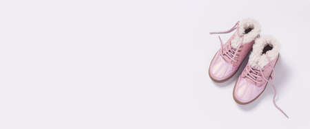 Fashionable children's pink shoes on a white background. Top view, flat lay. Banner