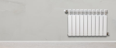 White heater against a marble wall. Central heating concept. Banner.の写真素材