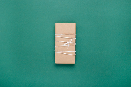 Gift wrapping on an emerald background. Top view, flat lay