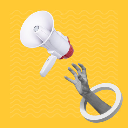 Hand catching a flying loudspeaker on a creative abstract yellow background.の写真素材