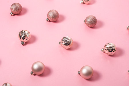 Background with beautiful shiny pink decorative balls on a pink background. Top view, flat layの写真素材