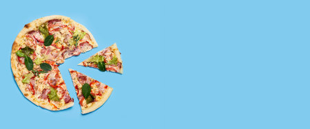 cut into slices fresh hot pizza on blue background. Top view, flat lay. Banner.