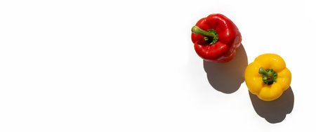 Yellow and red fresh peppers on a white background. Top view, flat lay. Banner.の写真素材