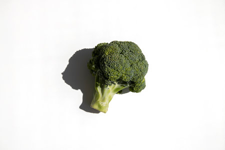Fresh broccoli on a white background. Top view, flat lay.