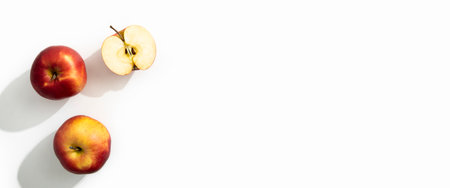 Whole, half apples on a white background. Top view, flat lay. Banner.の写真素材