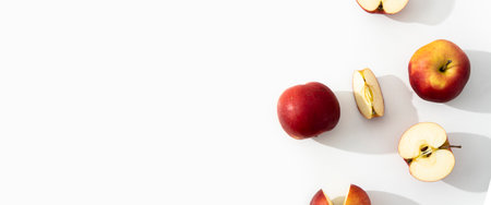 Whole, halves and cut apples on a white background. Top view, flat lay. Banner.の写真素材
